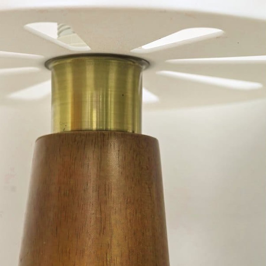 The Drum lamp’s wood base and brass-tone collar under the shade