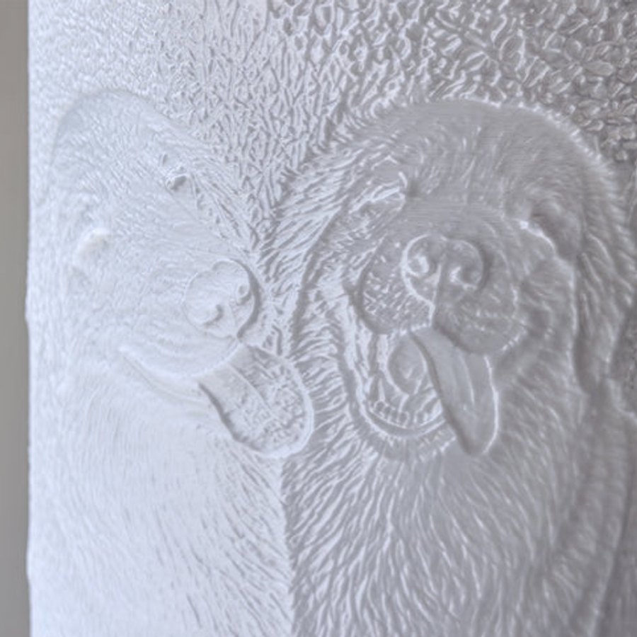 Close-up of a photo lamp shade switched off: two dogs carved as white relief