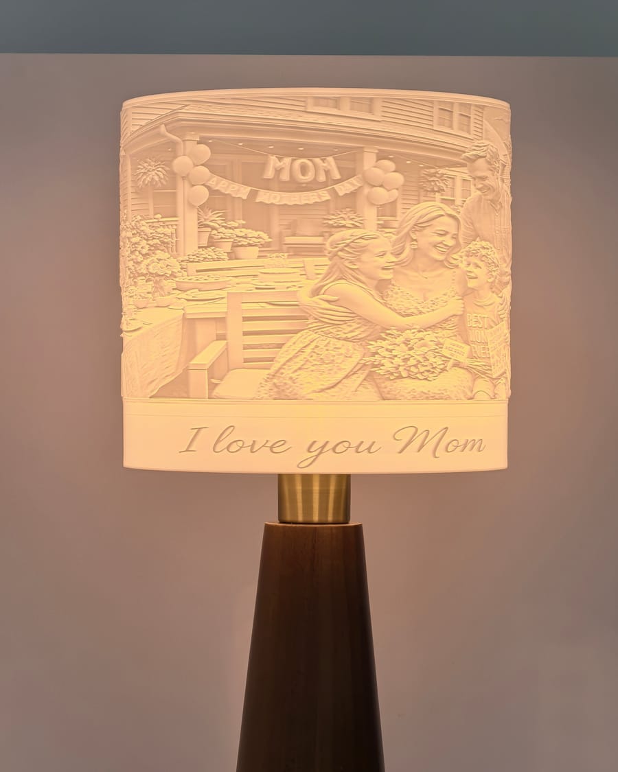 A Drum lamp with a mother and daughter portrait glowing in its shade