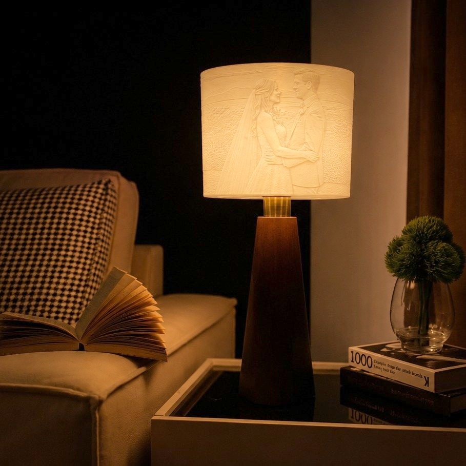 A Drum lamp beside a sofa, a wedding portrait glowing in its shade
