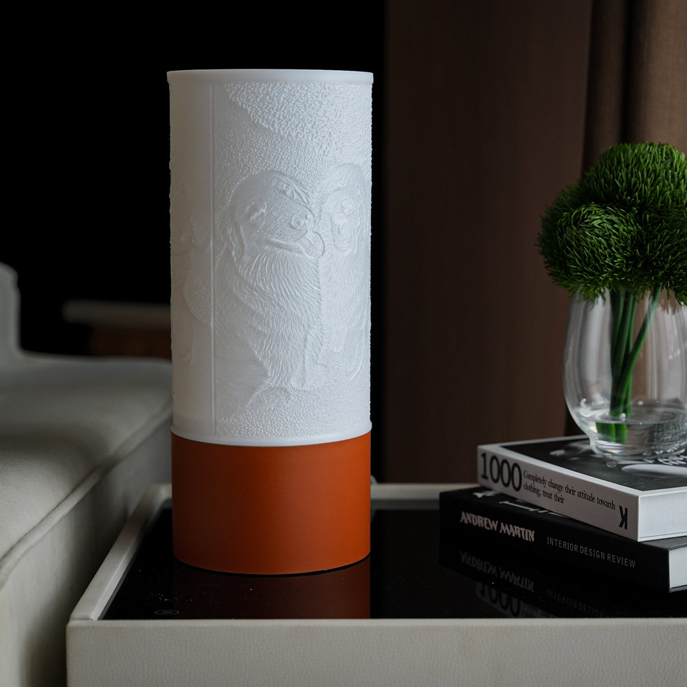 A Column photo lamp switched off: a white relief shade on an orange base